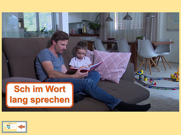Screenshot: Junger Vater mit Sohn auf der Couch beim Buch lesen. Er spricht die Sch-Wörter betont lang; Sprachforscher-App von LIFEtool